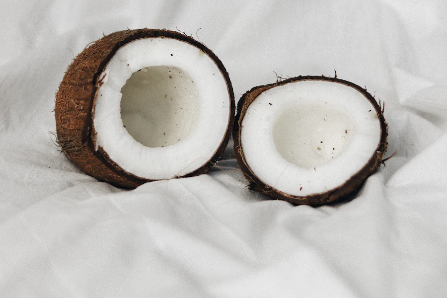 Fresh coconut halves on a neutral background