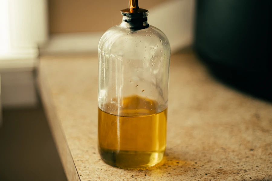 Golden cooking oil in a glass dispenser