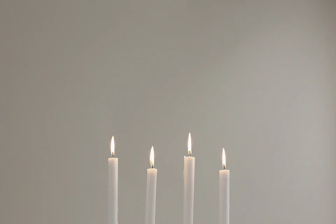 White taper candles illustrating wax applications